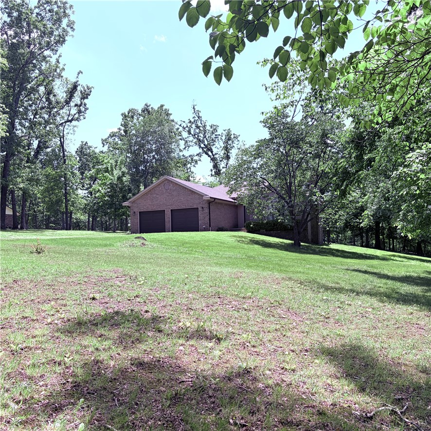 Tranquil setting close to everything Bentonville has to offer.  Custom built one owner brick home sits on a sprawling 3.77 acre lot that feels like your own private park. Oversized garage, 1 yo roof, hardwood floors, granite counters. Screened porch to enjoy the beautiful views.  1 mile to Coler Preserve!