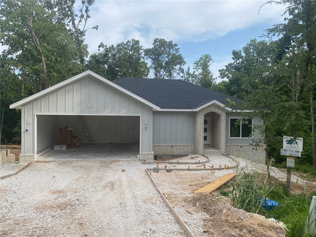 Don't miss the opportunity to own this beautiful new home located on the West side of Bella Vista, off Highway 279.  Tucked away on a quiet cul-de-sac with a newly paved street, this home offers convenient access to the Lago Vista Bike Trail and Lake Avalon. The thoughtfully designed split foot split floor plan features 3 bedrooms, 2 bathrooms, and an oversized 2-car garage. The living room showcases vaulted ceilings with decorative beams, creating an open space for everyday living and entertaining. The kitchen features a large peninsula with seating and plenty of prep and storage space. Wood flooring flows throughout the main living areas, hallway and primary bedroom and walk-in closet. Bedrooms two and three feature carpet, while both bathrooms and the laundry room are finished with tile flooring.Step outside to enjoy the covered back deck overlooking a gently sloping backyard. Take advantage of the opportunity to personalize select finishes and upgrades before the home's estimated completion in late August 2026.