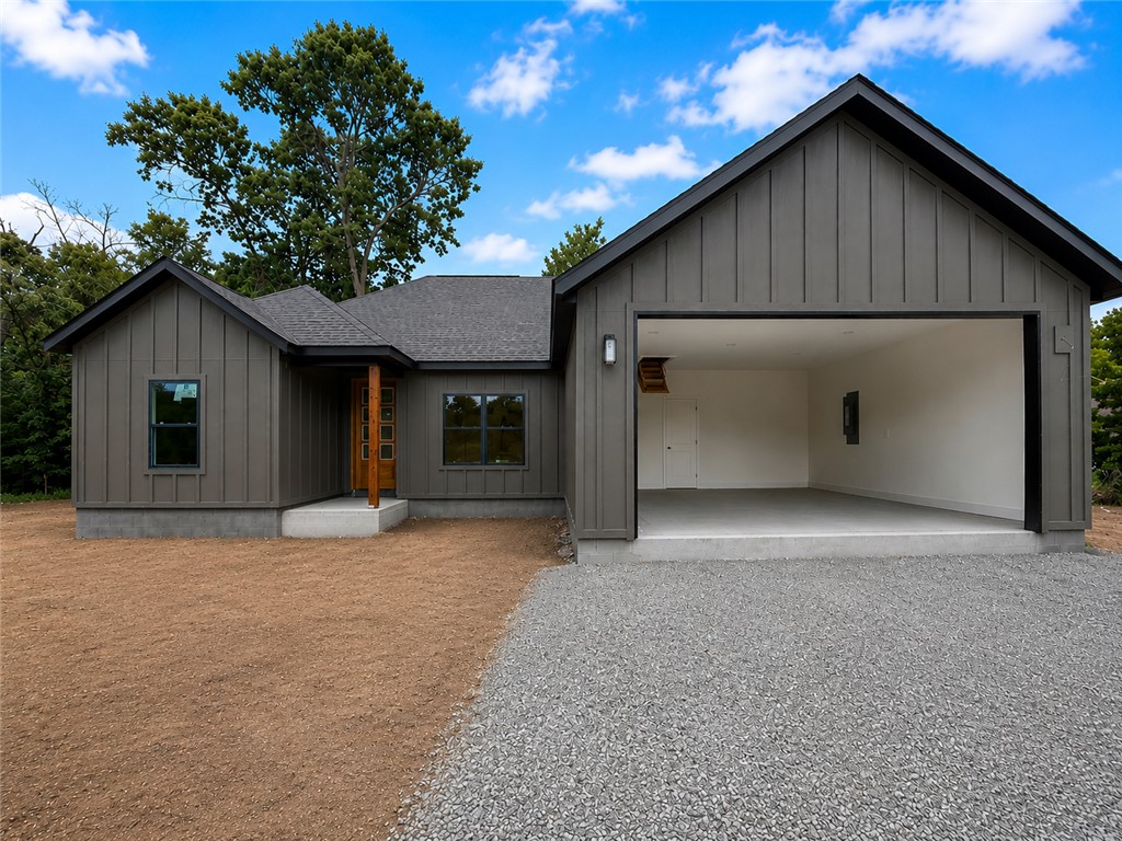 Welcome to 2 Boswell Dr in Bella Vista — a brand-new construction home blending modern luxury + functional design. This thoughtfully crafted home features 3 bedrooms, 2 bathrooms, and a dedicated office with eye-catching barn doors that make a statement. Step inside to an open-concept layout with a large living room centered around a cozy electric fireplace, flowing into the expansive kitchen designed for everyday living + entertaining. LVP flooring runs throughout the home, while the primary bathroom showcases elegant tile flooring, a custom walk-in tile shower, and a tub. The primary bedroom features beautiful wood beams across the ceiling, creating a warm + inviting retreat. The primary closet offers incredible storage space, with additional storage throughout the home. Situated on a slab foundation with a completely flat lot — a rare find in Bella Vista — this property will also feature Bermuda grass for easy maintenance and curb appeal. Comfort, convenience, and style come together in one exceptional package.