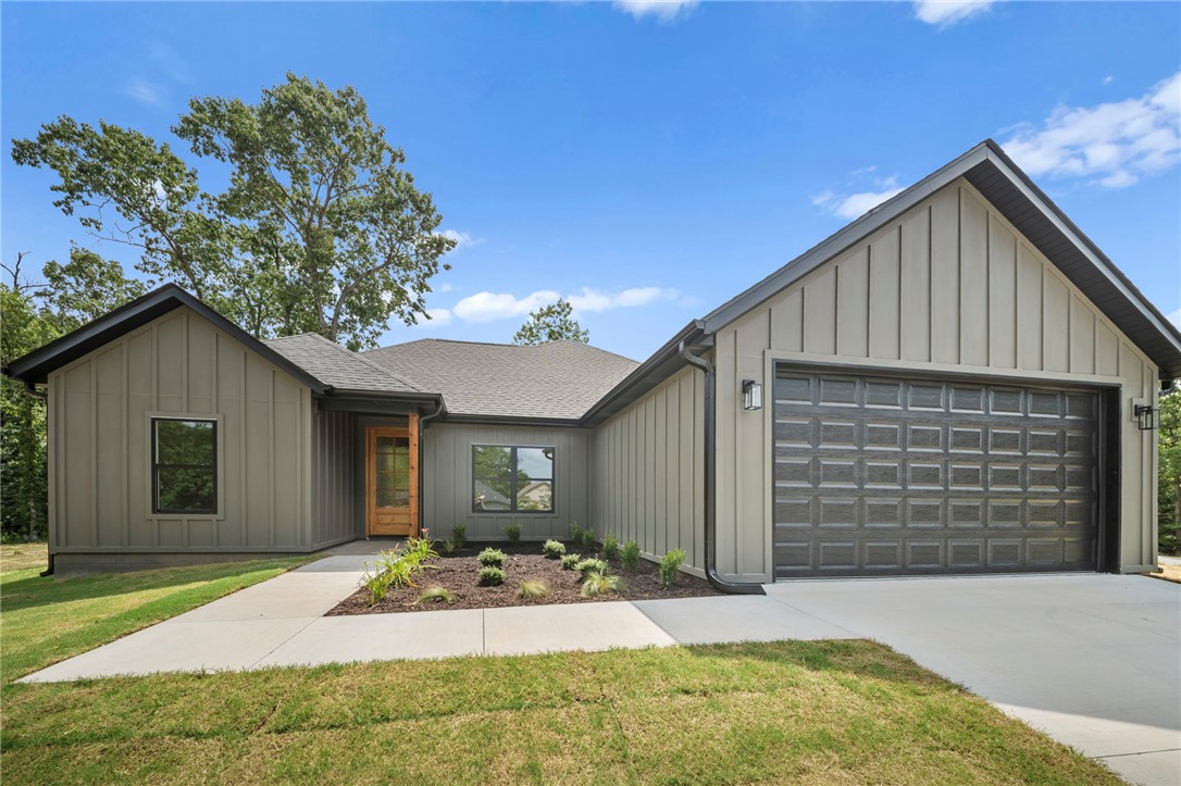 Welcome to 2 Boswell Dr in Bella Vista — a brand-new construction home blending modern luxury + functional design. This thoughtfully crafted home features 3 bedrooms, 2 bathrooms, and a dedicated office with eye-catching barn doors that make a statement. Step inside to an open-concept layout with a large living room centered around a cozy electric fireplace, flowing into the expansive kitchen designed for everyday living + entertaining. LVP flooring runs throughout the home, while the primary bathroom showcases elegant tile flooring, a custom walk-in tile shower, and a tub. The primary bedroom features beautiful wood beams across the ceiling, creating a warm + inviting retreat. The primary closet offers incredible storage space, with additional storage throughout the home. Situated on a slab foundation with a completely flat lot — a rare find in Bella Vista — this property will also feature Bermuda grass for easy maintenance and curb appeal. Comfort, convenience, and style come together in one exceptional package.