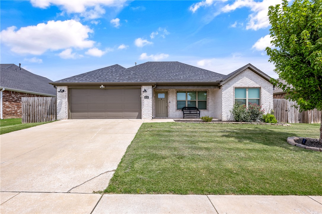 Welcome home to 1038 Jameson Street, this well maintained single-level home in Tontitown is ready to be your home. Inside, the open-concept layout connects the living, dining, and kitchen areas, creating a comfortable space for everyday living and entertaining. The bright kitchen features white cabinetry, granite countertops, subway tile backsplash, stainless steel appliances, pendant lighting, and a large island with seating and storage. The primary suite offers a vaulted ceiling, abundant natural light, and a private bath with an extended granite vanity and ample storage. Additional bedrooms offer flexibility for guests or a home office. A dedicated laundry room, built-in mudroom storage, tile flooring, and soft carpet add convenience. Outside, enjoy a large fully fenced backyard with room for recreation, gardening, or entertaining. Don't miss your chance to make this home yours!