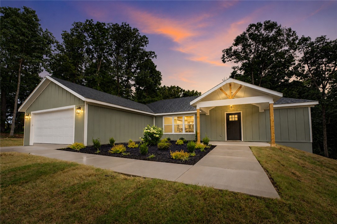 Experience quality craftsmanship and modern Ozark living in this custom-built home featuring a thoughtfully designed floor plan and premium finishes throughout. The spacious open-concept layout showcases stunning vaulted ceilings accented with beautiful pine beams, creating a warm and inviting atmosphere. The kitchen is equipped with elegant marble countertops, while durable luxury vinyl plank (LVP) flooring flows throughout the home for both style and functionality. Exterior features include low-maintenance Hardie Board siding for lasting curb appeal and durability. Enjoy the convenience of OzarksGo internet and cable services, providing reliable high-speed connectivity. Legal description and parcel number to be determined at closing.
