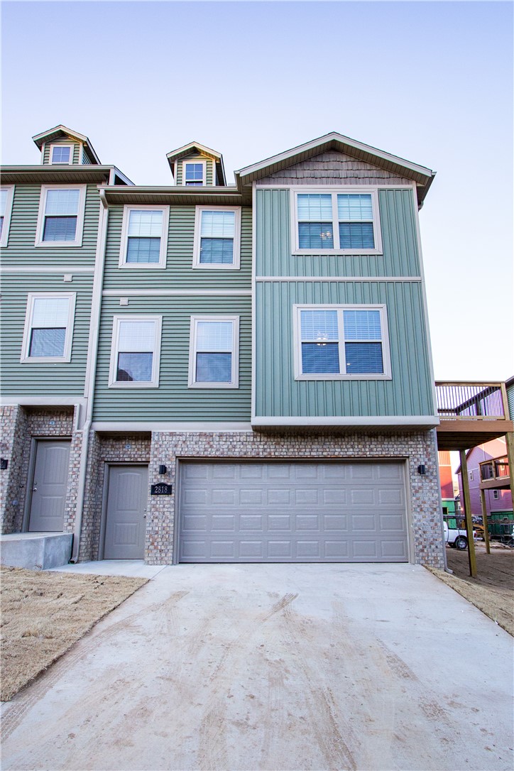 This townhouse is ideally located just minutes from the University of Arkansas campus and close to a wide variety of dining and shopping options. The three-level layout offers a garage on the first floor, with the main level featuring an eat-in kitchen, living room, dining area, and half bath. Upstairs, you’ll find two bedrooms, including a primary suite with a private bathroom and walk-in closet, along with an additional full bath and a convenient laundry area. The kitchen is equipped with stainless steel appliances, granite countertops, and a center island. The home is move-in ready! A deck just off the kitchen provides the perfect space for outdoor dining or relaxing while enjoying the peaceful wooded area around this property.