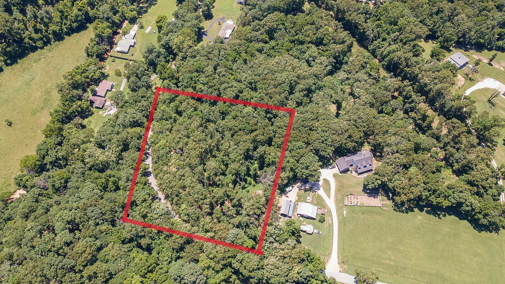 Looking for room to breathe without sacrificing convenience? This 5-acre homesite in desirable Little Flock offers the perfect blend of country tranquility and city accessibility. Just minutes from Rogers and Bentonville, you'll enjoy easy access to NWA's best shopping, dining, top-rated schools, and employers—all while coming home to your own slice of peaceful Ozark landscape.
A great building spot is ready and waiting; just clear a small area to make room for your dream home. Electric is already on site, making development that much easier. Buyer will need to install a septic system and tap into rural water.Whether you're envisioning a forever home, or investment opportunity, this property delivers the space and location savvy buyers are searching for in booming Northwest Arkansas. Don't miss your chance to build in one of the area's most convenient and sought-after settings!