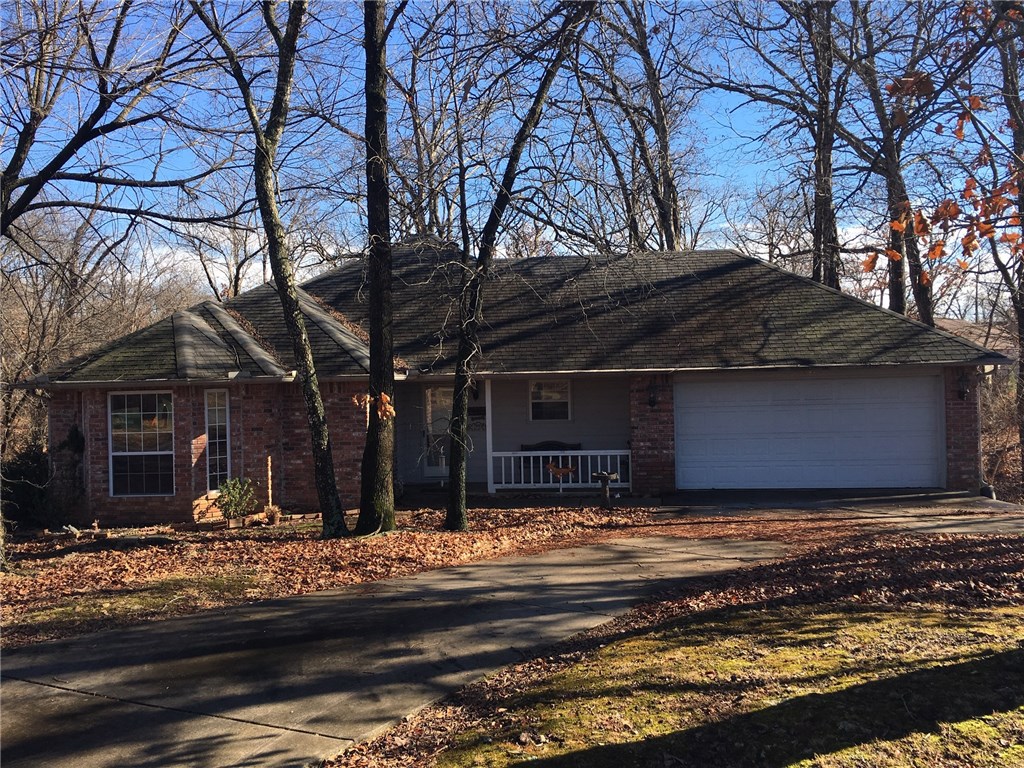 Three bedroom, two bath home in a desirable neighborhood. Kitchen has bar area for two bar stools and a built-in desk. Large attached two car garage.  209 sq ft finished basement room could be craft room or storm shelter(not included in the sq footage of the house).  Parking pad on the north side could be used for RV or boat parking or could accommodate a carport.  Beautiful wooded view from the back deck with wildlife.