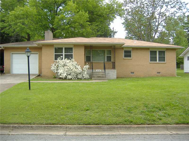 Great home on large lot!!! 3 bedroom and 2 bath, original hardwood floors throughout, original ceramic tile counters in kitchen and bathrooms,  fireplace in living room, fenced yard, refrigerator included.  1 car garage and additional carport.