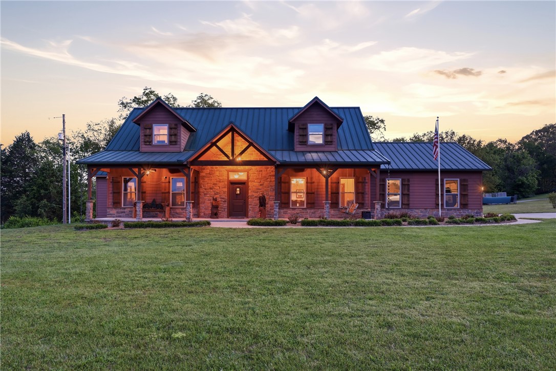 Resort style living! Spacious all-electric home at 5315 Hayden Rd in Pea Ridge offering a functional layout with 10 ft ceilings downstairs and custom crown molding. The living room features a cozy pellet stove, and the kitchen is equipped with a double oven for added convenience. The primary bedroom is located on the main level, while upstairs includes 4 bedrooms, a dedicated office, and 2 full baths, providing plenty of space for family or guests. Home features include two 80-gallon hot water heaters, generator wiring, and security system wiring. Enjoy outdoor living with a pool, hot tub, outdoor bar area, and a convenient poolside bathroom, ideal for entertaining. Additional highlights include a 30x60 shop and an automatic climate-controlled dog kennel.