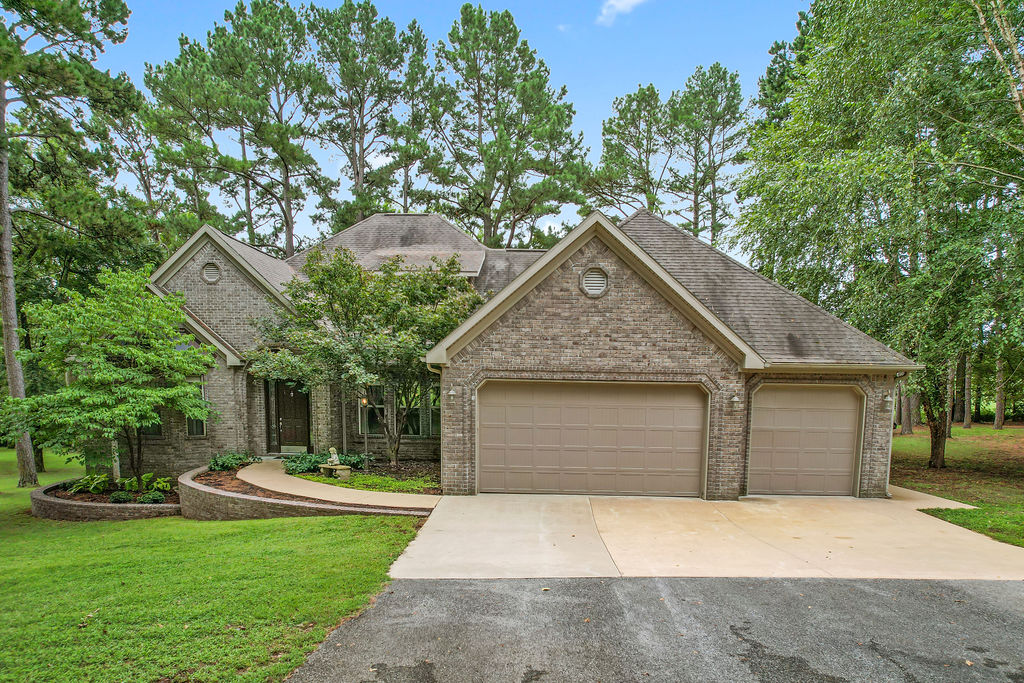 Amazing , like no other, one owner custom home within a wooded sanctuary, a three car garage w/ three buildings on Fayetteville’s Wyman Road on over 2 acres, this expansive 2,900 sq ft custom home is perfect for multi-generational living. With two primary suites and a third bedroom, plus an open floor plan connecting the gourmet kitchen and living area with optional formal dining room/office. The large sun-room provides additional area to relax and enjoy nature. A second building with a spacious 2,100 sq ft insulated/wired shop, built with the same high-quality materials, offers endless possibilities—convert into a guest suite, studio, or workshop. It also includes three-car garage for a total of 6 car garage spaces in total on site. Additionally, a third detached insulated/wired, 250 sq ft cottage-shed offering ample storage. Great space for extended family, a home office, or studio/shop, this home adapts to fit contemporary living. Town and Country living within minutes from the University of Arkansas.