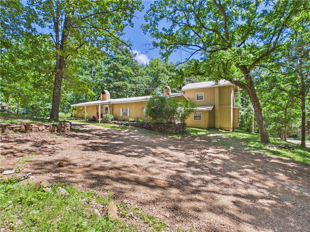 Set in a serene, park-like setting, this home offers a peaceful retreat surrounded by abundant wildlife and natural beauty. Enjoy the expansive deck, perfect for relaxing, entertaining, or simply taking in the peaceful surroundings. Inside, the spacious living area features a cozy wood stove that provides both warmth and efficiency. The kitchen offers plenty of space for meal preparation and gathering. With a generous floor plan, this home provides ample room for everyday living, entertaining, and accommodating guests. A large workshop offers excellent space for hobbies, projects, storage, or equipment. During wet weather, a natural pond enhances the property's scenic charm and attracts additional wildlife. Combining comfort, functionality, and a tranquil setting, this property is an ideal escape for those seeking privacy and a connection to nature