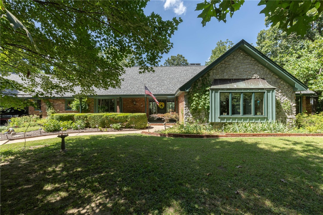 Location, location, location! Step inside this beautifully maintained ranch-style home situated on an expansive 2.34-acre lot in the heart of Fayetteville. Tucked into a quiet, established neighborhood, this property offers a rare blend of space, privacy, and unbeatable convenience. The home features a single-level layout with two spacious living areas, a generously sized kitchen ideal for gathering, and a dedicated workshop space. Enjoy warm Arkansas summers poolside in your own private backyard oasis. Whether you're looking for room to spread out or a place to entertain, this home checks all the boxes.
With quick access to nearby restaurants, shops, grocery stores, and trails, it’s hard to believe you're still in the middle of town. Properties like this don’t come along often—don’t miss your opportunity to call it yours.