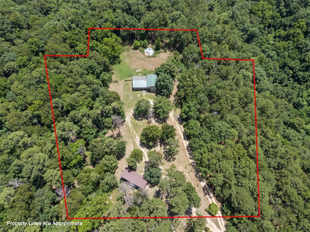 Opportunity knocks with these two unfinished homes on a really beautiful two and 1/2 acres just outside the Eureka Springs City limits. They have both seen better days and are in very rough shape and in need of extreme repair and renovations. You will be able to shape and mold them into whatever you desire. Multi-generational living, extra house as a guest cottage and reviving the "main house" or start a multi unit nightly rental. There is a one bed and one bath home as well as a two bed two bath home that are separated with a very nice sized yard in between. This is where you roll up your sleeves and build some sweat equity for your future! There are some damaged windows. The water source has been disconnected from the adjacent property. Both of these structures will need a water source. Quality and size of septic is unknown. This property has been court ordered to sell and will convey AS-IS with no seller property disclosure. Inspections are encouraged but No repairs or concessions will be made post inspection.
