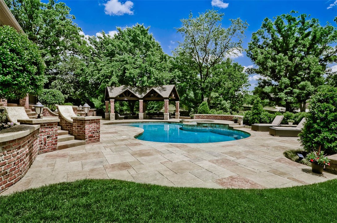 Stunning Home in Pinnacle Golf & Country Club. High quality, unique design, huge kitchen open to the living room. Wall of windows to view resort style backyard. Spacious master suite with enormous closet. Fully equipped media room plus extra game room. Two bedrooms on the main level. Laundry rooms on each level. Entertain around your in-ground pool, cozy up to the outdoor fireplace and built in grill. Enjoy the privacy of the .73 acres. Great curb appeal with this side load 4 car garage. Look no further, you are home!