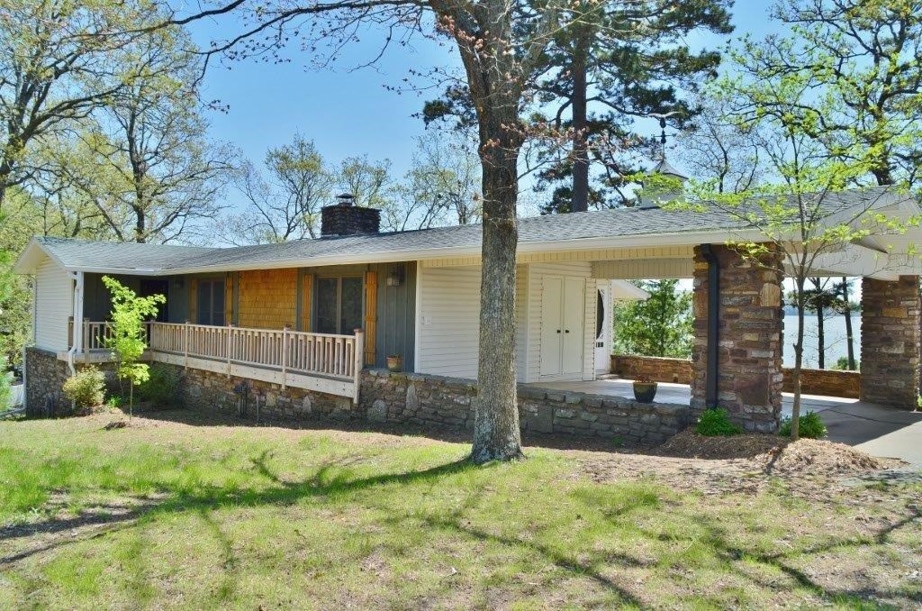 Beaver lake home that has been newly renovated. Lake front with dock access. Privacy fence with gated entrance. 3BR/2BA, kitchen opens up to living room w/wood burning FP, 1 BR & full bath on main level, 2 BR's & full bath, finished basement, sliding doors to outdoor sitting areas, extra storage, no carpet, built-ins, stainless steel appliances, and close to town. Come live at the lake and enjoy the views!
