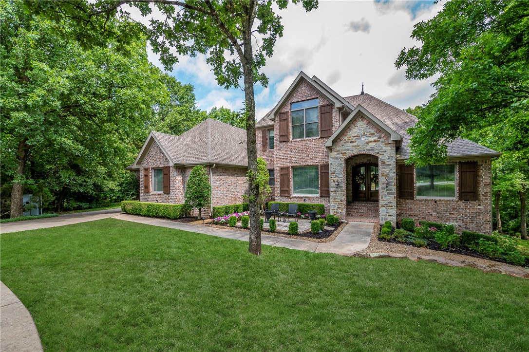 Absolutely Gorgeous golf front home in the prestigious gated community of Clear Creek and situated around the Renowned Blessings Golf course. Truly stunning! Entry features large windows, beautiful tongue and groove cathedral ceilings with skylights, engineered hand scraped wood floors, and formal dining. There is room for two chefs in this large kitchen with pantry and generous eating area.  Enjoy the outdoors on the screened porch. Master suite has a giant closet, massive walk-in shower and soaking tub. Every bedroom has an ensuite bath and upstairs has an additional washer and dryer. 
Walkout basement features large bonus room with bedroom, full bath and spacious kitchenette with wine closet!  This area is a great second living space,  mil quarters. All of this is tucked away on a quiet, professionally landscaped cul-de-sac  but still close to shopping, restaurants, medical facilites and schools and I-49.