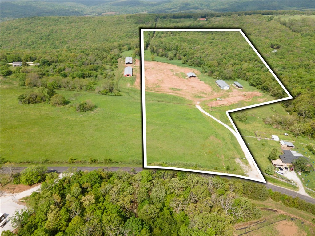 27MOL AC. In the Boston mountains in a great location on pave State Highway 265 about 20 minutes south of Fayetteville and close to Devils den State Park and recreation area. 10 to 15 minute drive to Prairie Grove, Greenland and West Fork. Property has a mix of pasture and woods and several building sites. Property includes a 40 x 90 shed with concrete floor and two overhead doors. New ozark electric power service and Washington water service in 2023. Endless possibilities on this property (RV park), campground, farmstead, prepped complex or even a business location. Property has elevation and gentle terrain. A beautiful slice of NWA.