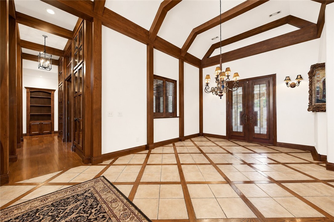 Walkable Location within a gated golf course community, this extraordinary custom-designed home by Harrison French Architecture and masterfully built by Marv Scherz spans two premium lots, offering unmatched craftsmanship and design. The French Country inspired home is highlighted by Colorado-crafted wood rafters, home showcases a chef’s dream kitchen with top-of-the-line appliances, dual islands, double sinks, and custom cabinetry with exquisite wood detail. Built-ins enhance your most cherished items. Home features a Library and home Theater, the primary suite is a retreat with soaring wood beams, a cozy fireplace, and a spa-inspired bath featuring heated floors, a steam shower, and a classic claw-foot tub. Outdoor living is equally impressive with a private backyard oasis, complete with an in-ground pool and hot tub, ideal for entertaining or relaxation. This residence seamlessly blends timeless architecture, modern luxury, and resort-style amenities in one of the area’s most coveted settings.