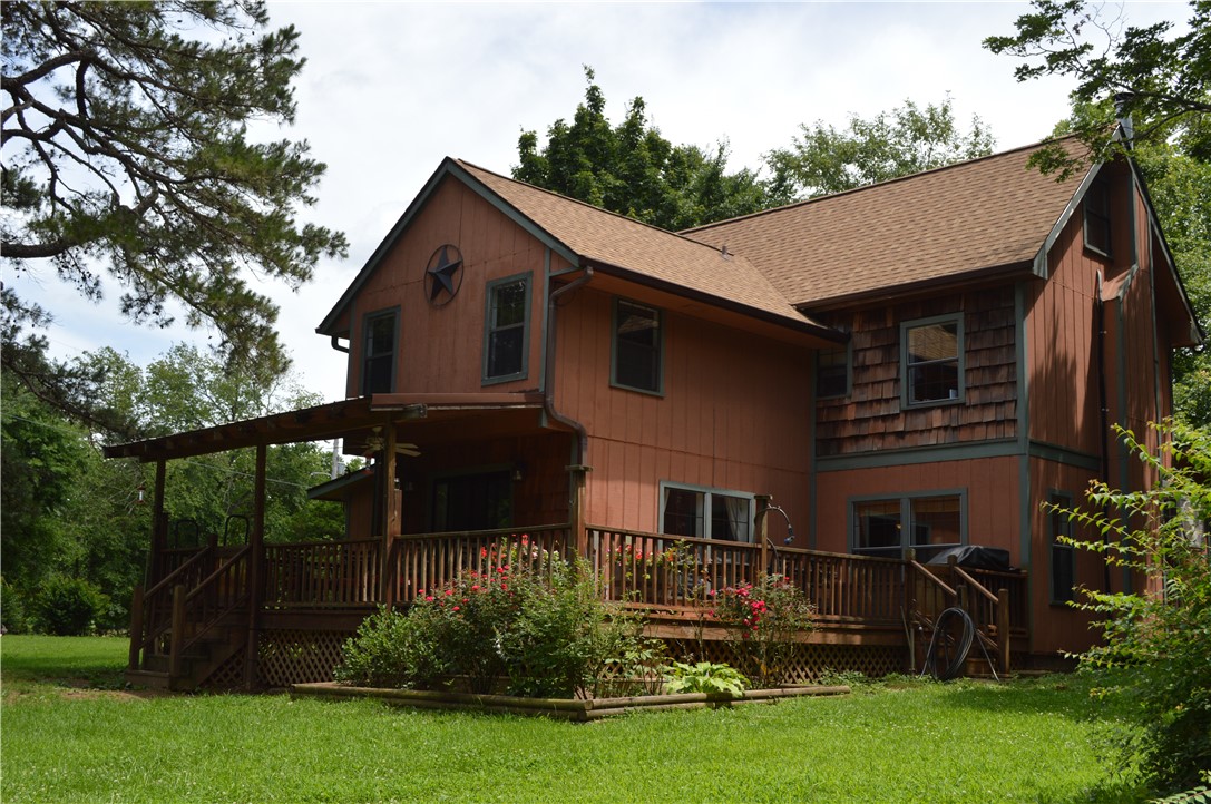This property has so many features to offer.  The expansive 6.7 acres offers an additional building site just below the main house suitable for a shop building or even possibly an additional home.  The primary home is located just a short walk away with cedar and spruce siding and all the rustic charm of a wooded retreat without ever having to drive on any rural / dirt roads.  An asphalt driveway runs the entire way to the home with gated access.  At the back of the property is a hidden pond with a live spring.  This property also offers an RV hookup site and exterior outlets and two outdoor farm type faucets.