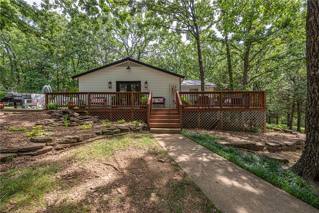 HOME SWEET HOME! This 3 bed 2 bath home on 5.47 +/- acres is what you’ve been waiting for! This property offers privacy while being 10mi from West Fork & I-49, & less than 30 min to Fayetteville & Prairie Grove. From the large wrap-around porch, head inside to an updated country chic interior w/ open-concept living area feat: beadboard detailing & wood laminate floors. L-shaped kitchen w/ center island, s.s apps, white cabinetry, granite counters, & composite sink. Relax in the primary suite feat pass-through closet & private ensuite ready for you to renovate! Enjoy two addtl beds & 1 full bathroom. Outside, the gently rolling land surrounded by mature trees offers privacy to enjoy your homestead w/ above ground pool, chicken coop & enclosed run, 1 Car garage/shop building (details like beadboard  & wood ceiling w/ mini split), 2nd shop space w/ 3 roll up doors perfect for projects, vehicles, or extra storage. With 5.47 Acres you’ll have plenty of room to explore too! Don’t miss out, act now!