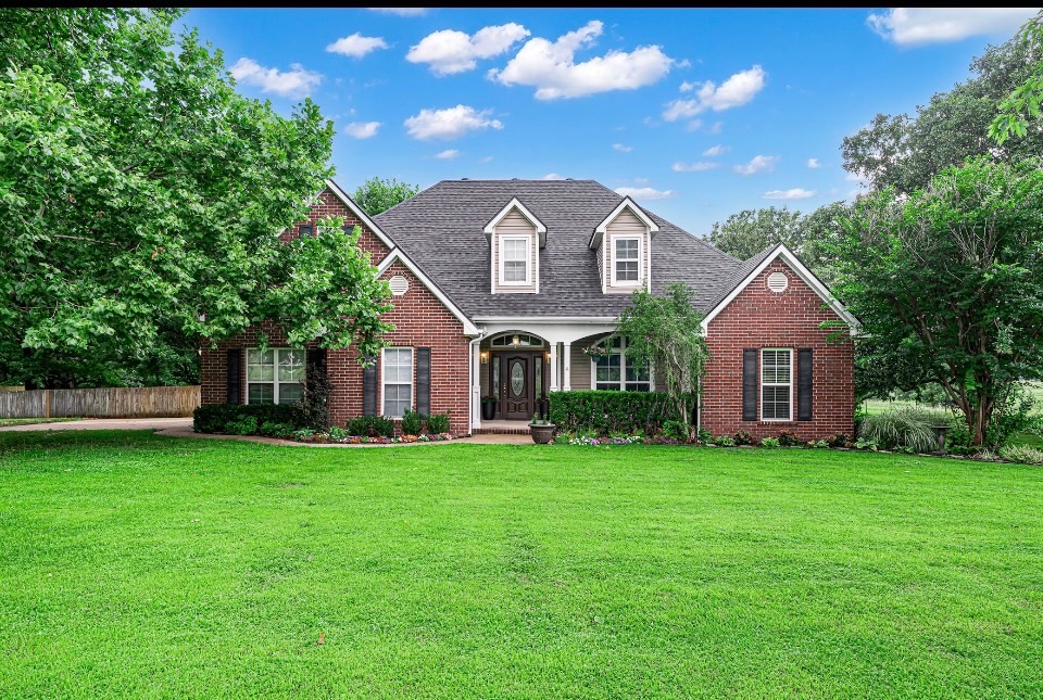 Well-maintained home on 2.5 park-like acres with a long winding driveway set back from the main road, mature shade trees & no homes behind! This home offers an open layout with vaulted ceilings, wood-burning fireplace, mudroom with a second entrance, sitting room that's perfect for an office with a view & a spacious kitchen with a gas range. 3 bedrooms & 2 bathrooms downstairs, plus a private upstairs bedroom with a half bath & walk-in closet. The main-level master suite has two walk-in closets, double vanities, large bathtub & walk-in shower. Relax on the covered front porch or oversized back deck overlooking the fully fenced backyard with a playhouse & in-ground storm shelter. The 30x40 shop includes a full bathroom, water heater & an HVAC unit that conveys but needs installation. New roof in 2026, newer HVAC, new upstairs carpet & fresh paint. Walk in attic. Great location while enjoying the peace & privacy of country living. Just minutes from the University of Arkansas, I-49, Arvest Ballpark. Springdale Schools