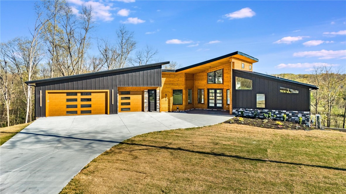 Welcome to Shelby Forrest, Pea Ridge's newest premier location featuring large, beautiful wooded lots all just minutes from the center of Pea Ridge, 10 minutes from downtown Rogers and only 15 minutes from downtown Bentonville. This modern masterpiece features modern design elements, magnificent views overlooking Big Sugar Valley, lots of windows bringing in an abundance of natural light, soaring ceilings, a chef's dream kitchen, a master suite that will simply wow any buyer, a second living space, media room and home office. You will fall in love with the outdoor space on the upper deck or lower patio area. This is truly a must see property.