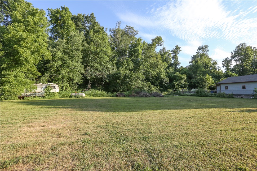 Investment Property. Sold AS IS,.The house is unsafe and dangerous to enter. DO NOT ENTER INSIDE THE HOUSE. Potential for Commercial Development , Currently 12 small lots with Two septic systems, two water taps . Connections for a trailer or additional home. Electric, water across north end (front) No interior showings. Part of the house and shed are built within the highway right-of-way.