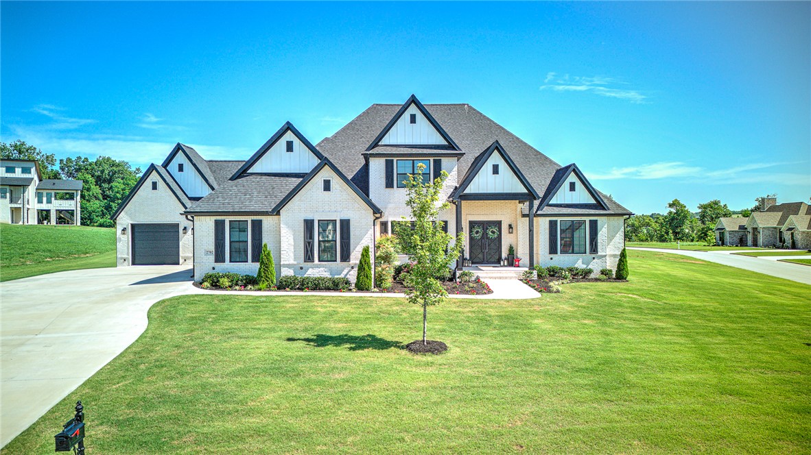 Check out this stunning 1 acre estate home in Healing Springs Subdivision, zoned to Bentonville schools. This custom home is packed with upgrades throughout, and thoughtful details. The main level offers an open living room and kitchen area, formal dining room, large eat in kitchen space and Buffet bar, butler pantry and coffee bar, double islands, formal office, large Laundry space, and hidden storage room under spiral staircase. The primary suite features a fireplace, spa-like bathroom, and access from large walk in closet to the laundry room .Upstairs includes the 5th bedroom, full bath, bonus room and media room with kitchenette. If you’re looking for space, this home has it! The 4th car garage currently features a designated gym space. Outside, enjoy a covered porch with built in fireplace and perfect grill and entertaining space. This home has it all and we’d love to give you a tour!
