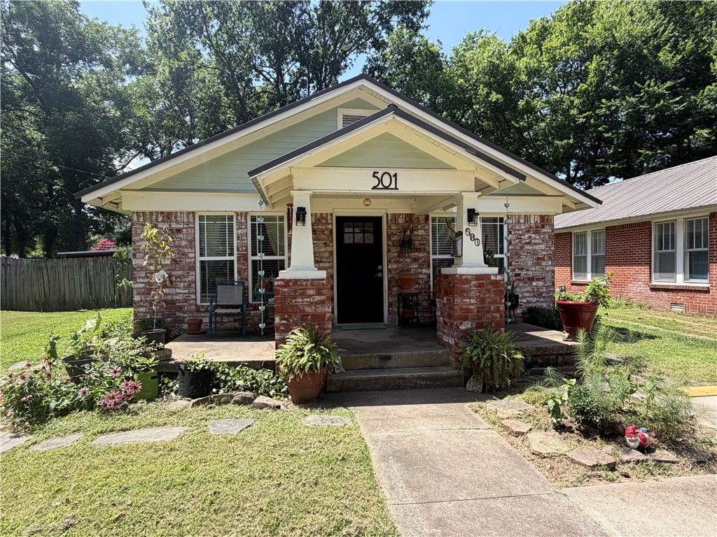 Just blocks from Russellville’s vibrant downtown entertainment district, this charming 2BR/1BA home offers character, comfort, and extensive updates! Enjoy a spacious covered front porch, beautiful hardwood floors, remodeled bathroom, updated windows, and a bright, inviting layout. The fenced backyard is shaded by mature trees and includes a large storage building/workshop with shelving and a workbench. Major improvements include metal roof (2012), added attic insulation (2013), new driveway (2014), new footings/piers/beams, Tyvek wrap with added wall insulation, re-laid brick exterior, French drains, windows, bathroom, electrical panel, and living room subfloor/flooring (2018), plumbing updates (2018 & 2022), new water main (2022), new HVAC and water heater (2024). Prime location close to shopping, dining, parks, and schools. Perfect starter home, downsizing opportunity, or investment property!