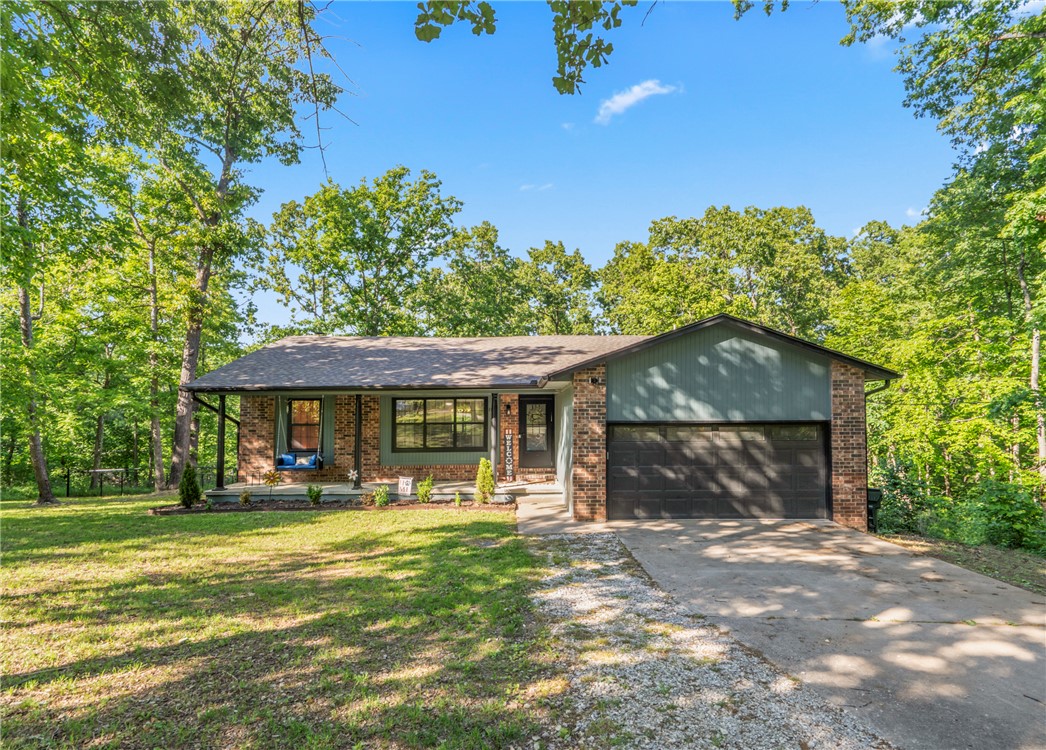 $6500 Preferred Lender Credit! Tucked away on 1.43 peaceful acres, this beautifully remodeled home offers the perfect blend of privacy, space, and modern comfort. This 4-bed, 3-bath home features an open floor plan, two levels & two spacious living areas, including a downstairs retreat with a cozy wood-burning fireplace and an oversized bedroom with private bath that works perfectly as an in-law suite or second primary suite. Completely gutted and remodeled in 2025 with luxury vinyl plank flooring, ceramic tile, granite countertops, and freshly painted gray cabinetry with abundant storage. Includes two stunning custom tiled walk-in showers, double sinks in the main primary suite, & thoughtful updates throughout. Recent improvements include a new hot water heater, new plumbing on the primary bedroom side of the home, extensive backyard clearing, a fenced backyard, plus added overhead garage storage & a workbench. Enjoy the peaceful wooded setting from the covered front porch, deck, or patio, all perfect for
