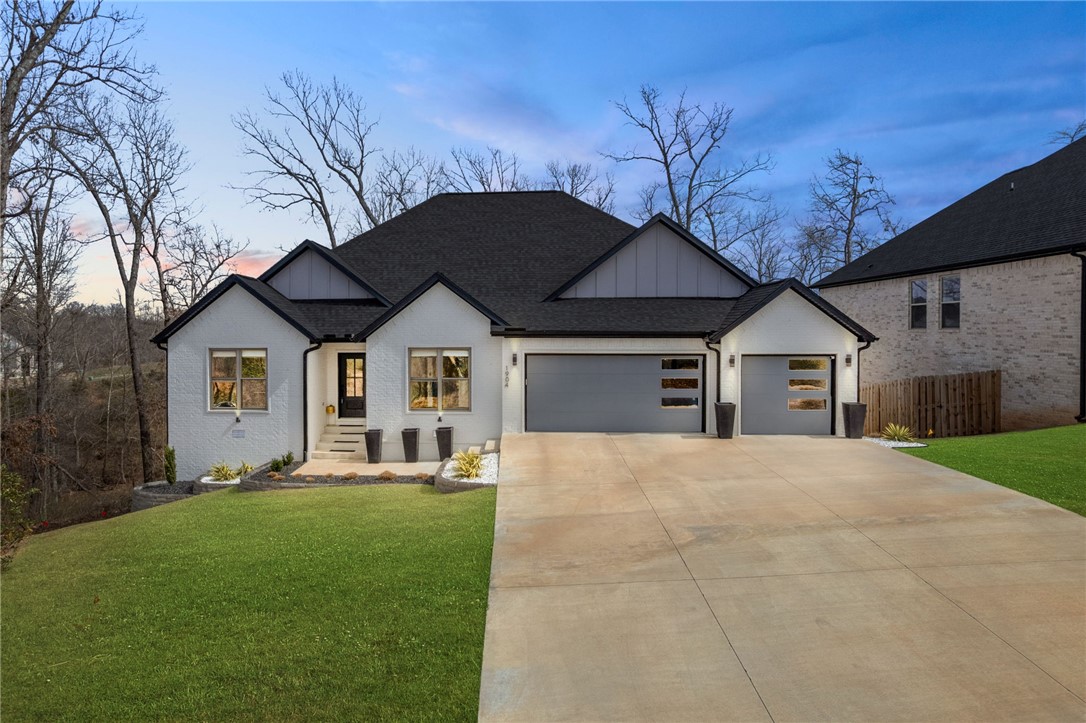 Minutes from DT Bville, modern-organic style is brought to life in this Bentonville gem built for those with affection for the outdoors. The decks meld indoor and outdoor entertaining spaces, and the location yields immediate results for those seeking refuge or adventure with the community pool steps away and Bentonville's best MTB trails running into the subdivision. This large 4 bed 4 bath home has a separate office and also 2 bedrooms on the main floor. Every bedroom has an ensuite bath. Kitchen features gas cooktop with hood and pot filler, big island with seating and storage, high-end appliances, and butler's pantry leading to the dining room. The living room is open with soaring ceilings, a fireplace, and an accent wall. Vaulted ceiling in the primary bedroom and a spa-like bathroom that loops directly into the laundry from the closet. Lower-level 2nd living area with 2 beds, 2 baths and access to the yard with park-like landscape and edible berries! Handcut Hollow MTB Park from sub! Great schools see photos!