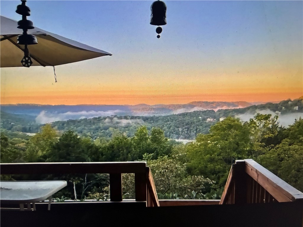 Beautifully remodeled and landscaped chalet over looking Table Rock Lake! Breathtakingly Spectacular Views from sunup to sundown!  The vapor rising from the Vista below is a site to see from the balcony, sunroom or open living room and kitchen.  A brand-new, expertly designed back porch extends toward the skyline, offering an inviting outdoor space with scenic views.  This unique and peaceful home has mountain-lodge architecture, natural wood finishes, and a cozy, rustic feel, nestled in the heart of the Ozarks!  Thoughtful design updates throughout the home addressing both form and function.  Holiday Island is a quiet community with with 2 Golf Courses (27 holes), 2 swimming pools, a full-service Marina, Kayak/Paddle Board (no-wake) cove and sandy beaches, all of this just ~5 miles from Historic Eureka Springs! 
Kitchen cabinets are currently being installed.  Interior photos will be taken upon completion.