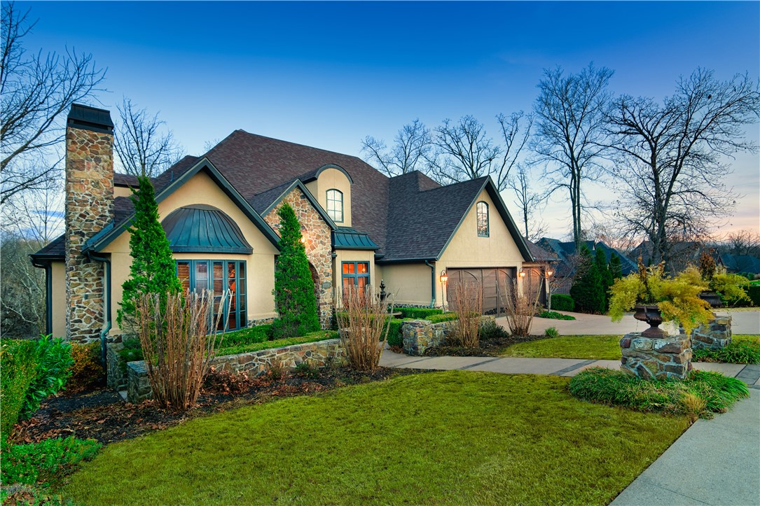 This one-owner home oozes Italian romance. Located less than a mile from Crystal Bridges Museum entrance & near all Downtown Bentonville has to offer, including Walmart Home Office. Be ready for gorgeous sunrises while listening to the creek from the back deck with no rear neighbors to obstruct your view. Enjoy the neighborhood walking trails leading to the community clubhouse & pool. Hosting guests will be a breeze in a 7,174 sq. ft., 5 bedrooms & 5.5 bath home. The private office entrance is lush w/ green-space leading to a stunning theater room, built-in custom craft room & 2 built-in office suites. A top-level bonus room leaves endless possibilities. Home boasts 7 custom walk-in closets, smart home w/ alarm system, all lights on dimmers w/ programable motion censored brighten up lights, hand-scraped wood floors, outdoor fountain, laundry shoot, multiple walk-in attic access & many pocket doors for easy flow. Schedule your private tour to see this beautiful home making its debut in the Northwest Arkansas market.