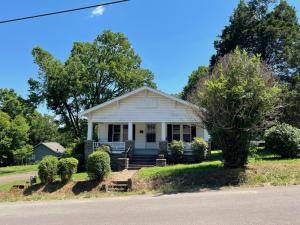 A Classic Craftsman home with a new roof and large wooden columns on a big open front porch.   An open living/formal dining area features new flooring.  Onward to the kitchen w/ breakfast nook and adjoining laundry offers shiplap/ wainscoting walls!!! A bonus sleeping porch is at the rear of the home that could be used as a 3rd BR or office space. Situated on a sizeable lot w/ storage shed & attached garage just above Historic Clarksville. Call and schedule your showing today!!