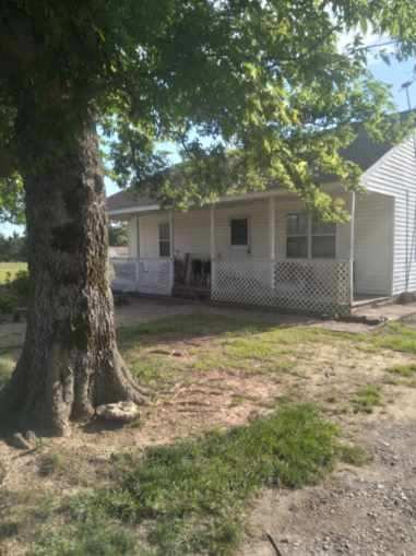 Enjoy the best of country living just a couple miles from town! This charming 2-bedroom, 1-bath home offers approximately 1,200 sq. ft. of comfortable living space, perfectly situated on around 2 acres. The property includes a barn with partial fencing—ideal for animals, hobbies, or extra storage—and plenty of flat, usable land ready for a garden, workshop, or whatever you envision. Connected to rural water for added convenience, this property makes a fantastic starter home or a peaceful place to downsize and unwind.