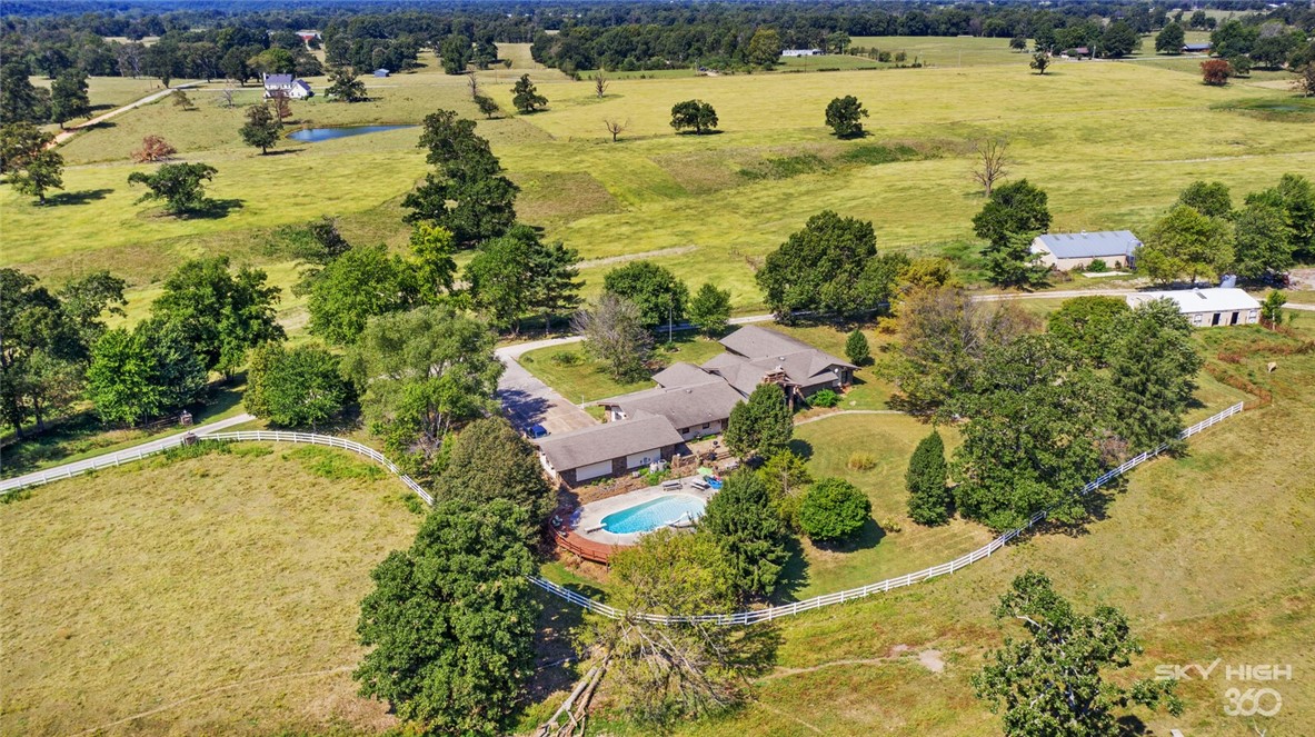 An established homestead on 147 rolling acres, once a working farm, now a prairie and pasture land, a 5 acre lake and fresh water spring are rare and beautiful to find. This 1973 prairie ranch style house is situated on wide opens space. It is conveniently located acreage as it is only 5 minutes from the new Bella Vista Bypass, 15 minutes to Bentonville and less than 10 minutes to I-49 with multiple access points from the property surrounded by road frontage. Seller will not divide. The listing agent must set up showing appointments and potential buyers must have proof of funds before setting up a showing/per sellers instructions.
