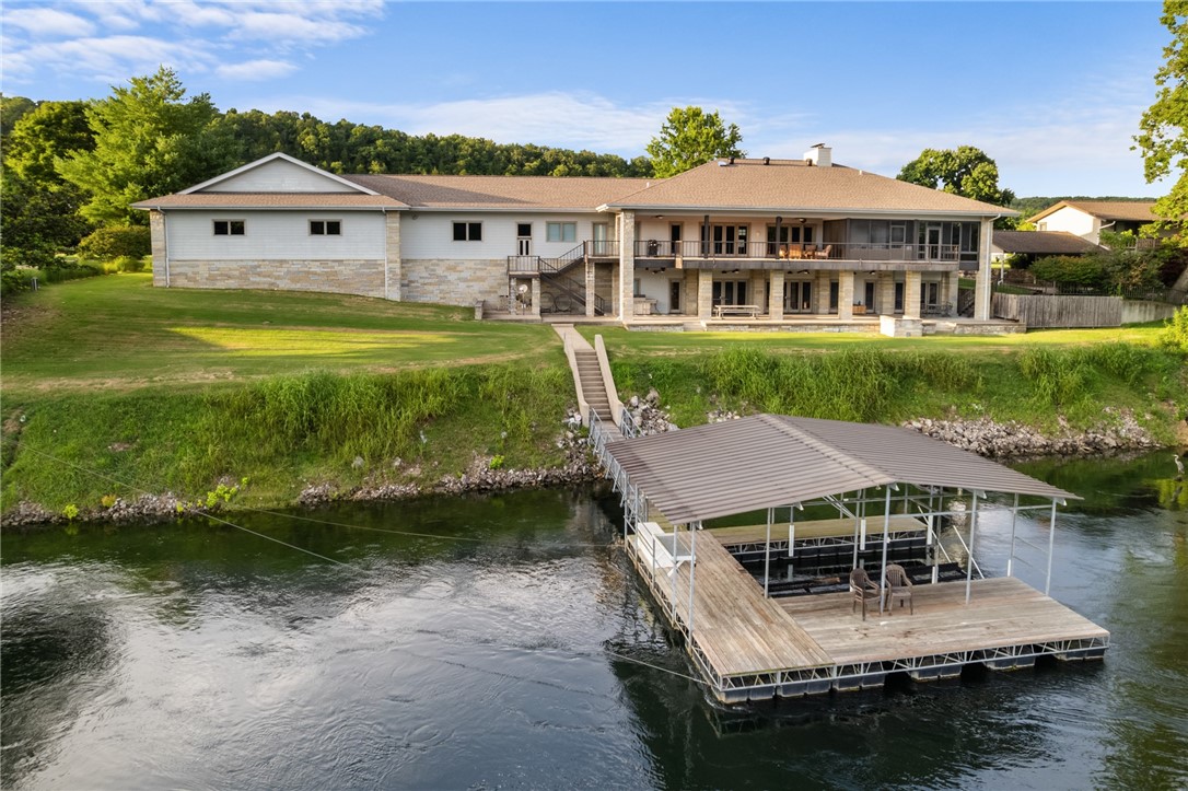 Exquisite riverfront residence located within the prestigious Airport community. This meticulously crafted home features 3 Bedrooms and 3.5Baths, showcasing a wealth of high-end updates including crown moldings & 3/4-inch hardwood flooring. The chef’s kitchen is a culinary delight, custom maple cabinetry, solid surface countertops, butler’s pantry. The expansive master suite offers a luxurious en-suite bathroom, a cozy sitting area w a fireplace, a walk-in closet, and a private lanai complete with a hot tub area. The lower level is designed for family gatherings, featuring kitchen, LR with a fireplace, game room, wine cellar, bedroom, and a safe room. With a stunning real stone exterior complemented by low-maintenance concrete siding, this home is built to last. The outdoor space is exceptional, featuring a large covered tiled concrete patio that offers breathtaking views of the river & access to your private boat dock. Additionally, a two-car garage and a 43’x35’ airplane hangar.