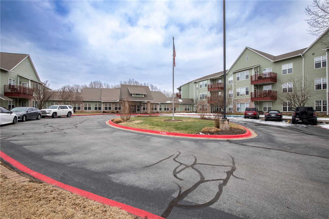 The Plaza at Highlands Crossing is a Senior Housing CO-OP. There is a Fitness room, shop/craft room, 36 sq ft of personal storage area, lobby/bar weekly events area, indoor mailboxes and much more. This apartment has new paint, new carpet, new washer & dryer, is a 2-bedroom, 2 bath with living room & kitchen. It comes with one covered parking space and open parking spaces for additional vehicles. Buyer must be 55 or over.  Lifetime warranty on all appliances included in $1,328.60 monthly fee that also covers water, electric, taxes & POA dues.