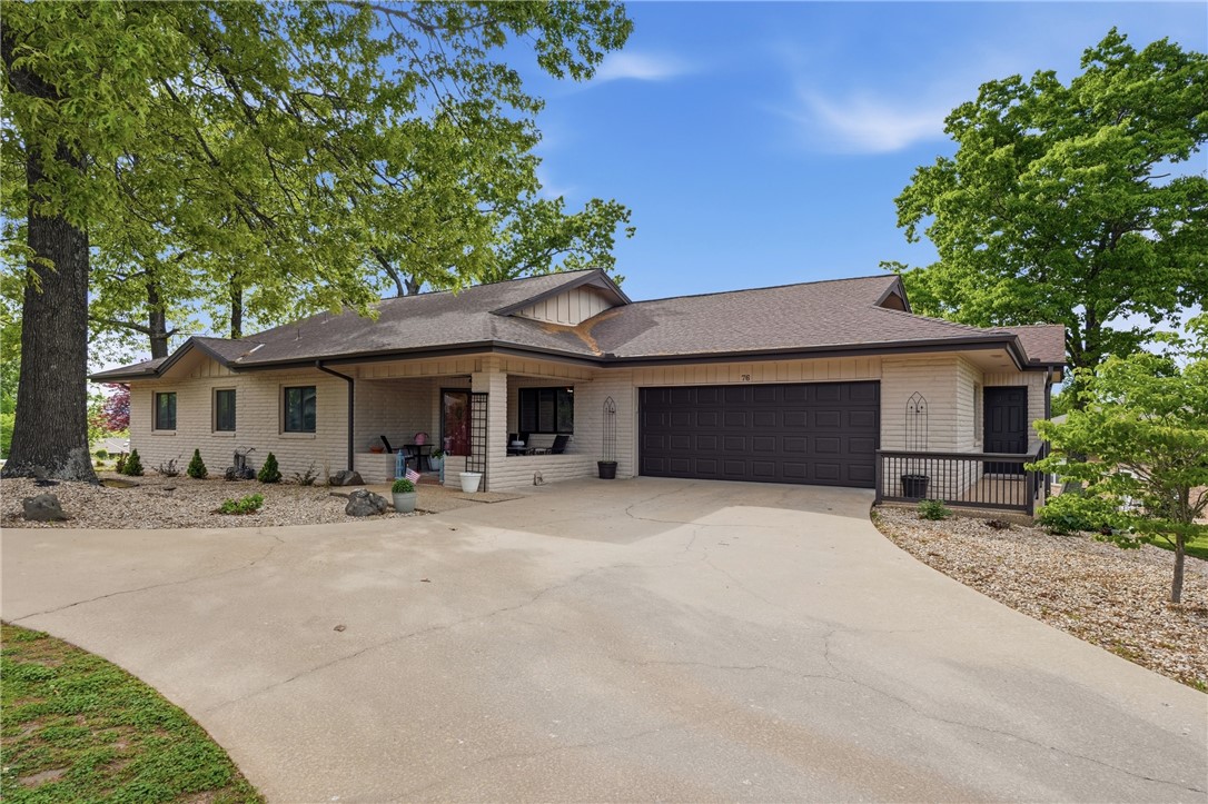 This 3 bed, 2.5 bathroom ranch-style home offers classic character with modern updates. Situated on a large .43 acre corner lot, the property provides plenty of room to enjoy both indoor and outdoor living. A large covered front porch invites you sit and watch the world go by. Inside you'll find light colored paint and laminate floors throughout most of the home for easy maintenance, large living area with several windows for plentiful sunlight and outdoor views, and kitchen with pantry and ample cabinet space. Outside is a full painted brick exterior and landscaping for timeless curb appeal, while the expansive deck wraps around from side to back. Last but not least are the extra storage rooms by the garage. Located just a 3 minute drive to Lakepoint Marina and Loch Lomond, this home offers peaceful living with quick access to Bella Vista's many recreational activities, as well as dining, shopping, and everyday conveniences. A truly unique property with character, comfort, and location all in one.