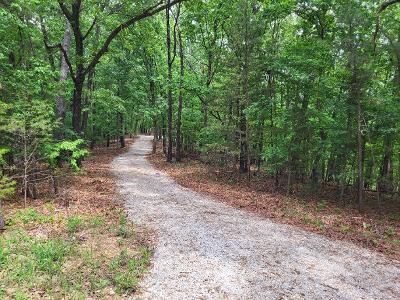 16.38 +/- acres of privacy and natural beauty! Perfect location to build your new home!  Property features a 300 ft. graveled driveway with large, graveled RV pad. Expansive flat (thumb) on the top of the stunning acreage with a seasonal creek at the base of the hills. Large ridge with multiple great building sites, electricity available at the top of the driveway making it accessible for your forever home. Lots of mature dogwood, redbud, hardwoods, and pines makes it easy to enjoy the abundance of wildlife for outdoor enthusiasts. Total privacy with a private road connecting to a paved road leading into town with historical sights, great eating places and lots of shopping! Quiet, peaceful setting-a true retreat. AT&T have strong service at the property.