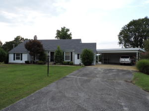 Stately home on 1 acre with park-like setting at the edge of town. Spacious interior with living room, formal dining room and den. Some hardwood floors. New roof. Stone and vinyl exterior. Newer heating and cooling unit. Gas log fireplace. Good closet space and lots of storage space. Extra large deck is private with pretty view.