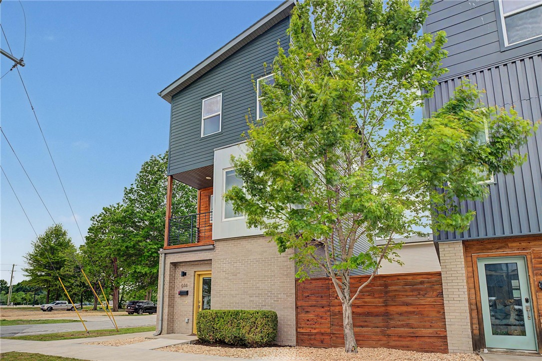 Located only blocks away from Downtown Bentonville, the new Walmart Home Office, new Gateway park, future STEM university, and Thaden School, you will fall in love with the convenience of this bright and open home. Experience modern luxury in this beautiful 2 bed, 2.5 bath, 3-story like-new home nestled between the cultural and executive subareas of the 8th Street Corridor. With easy access to bike trails, shopping, and dining, this home is ideal for professionals or those relocating. The 3rd level features 2 bedrooms, each including an en-suite bathroom, along with a utility area with a washer and dryer. An open-concept kitchen and living room offers ample natural light to provide an inviting feel on the 2nd level. Additionally, a half bath and a balcony overlooking SW B St complete the 2nd level. Heated bathroom tiles throughout, wood floors, and upgraded epoxy floors in the garage add to the executive-quality finishes. Recent updates include fresh paint, landscaping, and new carpet in bedrooms.