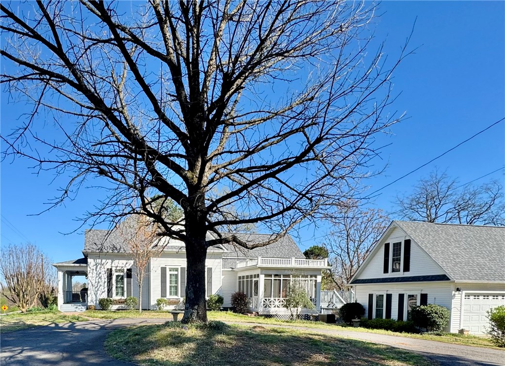 Step into timeless elegance with this beautifully restored historic home, originally built in 1910 and thoughtfully remodeled in 2018 to blend classic charm with modern luxury. Nestled on a spacious 0.80-acre lot, this stunning property offers the perfect balance of character and comfort.
Inside, you’ll find exquisite brick tile and rich hardwood floors that flow throughout the home, creating a warm and inviting atmosphere. The heart of the home is a true chef’s kitchen, complete with high-end finishes, a cozy fireplace, and a striking coffered ceiling—perfect for both everyday living and entertaining.
Enjoy quiet mornings or relaxing evenings in the charming enclosed porch or back deck, both perfect spaces to unwind and take in the beauty of the surrounding property. Outside, the home continues to impress with a detached garage offering ample second story storage and a convenient circle drive that adds both functionality and curb appeal. This is a one-of-a-kind property!