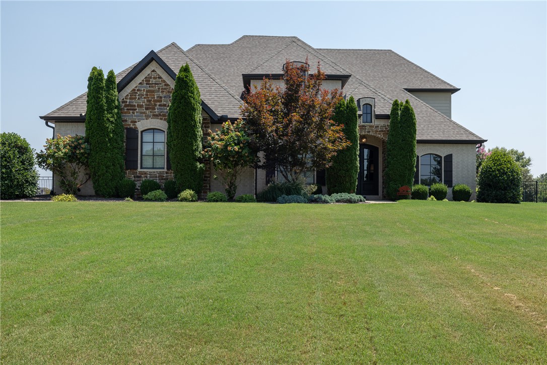 Don't miss this incredible opportunity to own a stunning custom home in the highly sought-after Estates at Dogwood Canyon. Situated on a desirable corner lot, this 3,892-square-foot home offers modern elegance, upscale finishes, and a thoughtfully designed floor plan. The spacious living areas are filled with natural light, creating an inviting atmosphere perfect for everyday living and entertaining. The covered patio with a fireplace is ideal for hosting family and friends, while the expansive backyard offers plenty of room to add a custom pool. The private primary suite is conveniently located on the main level, with the remaining bedrooms and bonus room upstairs, providing comfort and privacy for family or guests. Combining exceptional curb appeal, luxury finishes, and outstanding indoor and outdoor living spaces, this remarkable home offers the perfect blend of style, comfort, and convenience. Don't miss your chance to make it yours.