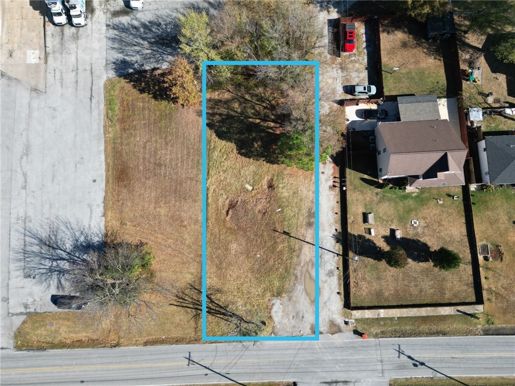 Vacant lot ideally situated just off US 412 and near Springdale Municipal Airport, offering excellent access to major roads with high traffic volume. Surrounded by a full range of amenities, this property is zoned for commercial use, presenting a prime location and is just 5 minutes from downtown Springdale. Please note: The marked boundary lines are approximate and do not represent the exact lot measurements.