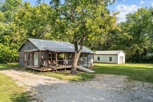 This cozy 3 bedroom 1.5 bath home is move in ready and sits on .47 acres. Need a shop? Look no farther. You will have a place for your atvs, boats, and lawn equipment. This home has all neutral colors through out and offers an open layout in the kitchen and living room. This home offers an abundance of natural lighting. New roof and new HVAC. Whether your looking for a getaway home, airbnb, down sizing, or a first time home buyer, this home fits will fit all your needs!