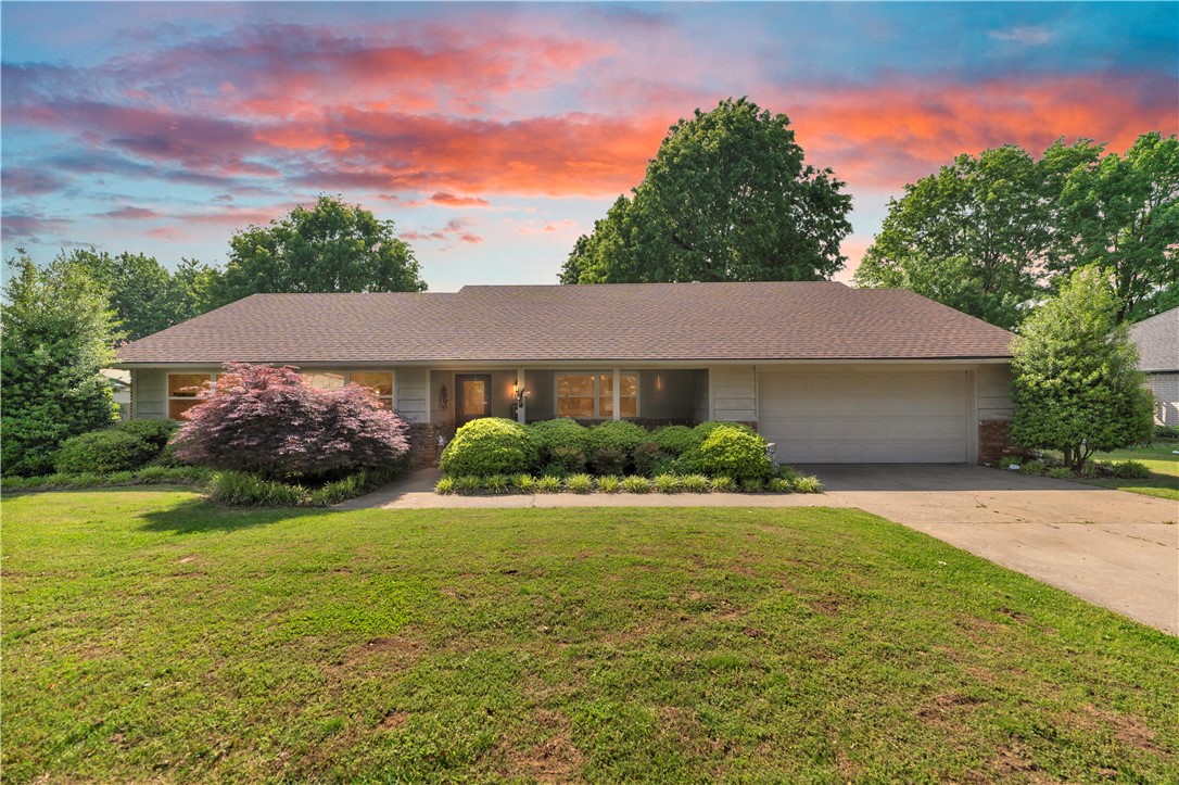Lovingly maintained traditional brick ranch offering warm, inviting living spaces and a layout designed for everyday comfort. Features include multiple living areas, a cozy wood burning brick fireplace, and an elevated back deck overlooking a flat .40 acre lot with mature trees providing ample shade and a peaceful backyard setting. Updates in the past couple of years have created a move-in ready home with room to make it your own. Conveniently located 2.5 miles to booming Downtown Springdale, .5 mile to either Neighborhood Walmart or Harps Food Stores and much much more.