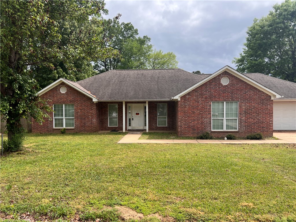 Welcome to 505 Briarwood in Perryville, AR — a home full of potential and ready for your personal touch! This spacious home features an open living and dining area with a brick fireplace and abundant natural light throughout. Flooring has been removed in several rooms, giving you the opportunity to customize the finishes to your style. * The large primary suite includes walk-in closets, a walk-in shower, and a jetted tub. Two additional bedrooms are separated by a guest bath with a shower/tub combo. The kitchen is a complete blank slate with no cabinets, counters, or sink, ready for your dream design. Off the garage is a large mudroom with washer/dryer hookups and space for the hot water heater. An additional flex room between the kitchen and mudroom could serve as an office, dining area, or hobby space.  ** Power is currently off at the property. A certified electrician is recommended to assess what is needed to restore electricity. * Great opportunity for investors or buyers looking to create a custom home!