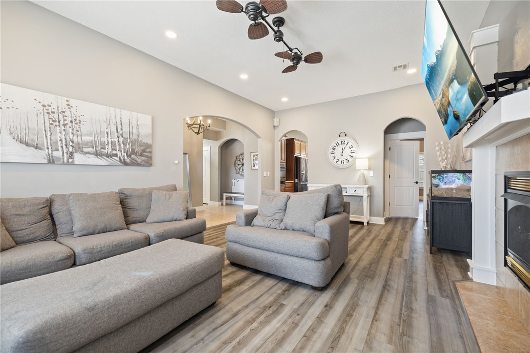 Built for real life with flexibility in mind, this spacious 5-bedroom, 2-bath home offers room to grow and gather. The main level features four bedrooms in a split floor plan, with a private primary suite set apart from the secondary rooms. Arched doorways add warmth to the living spaces. Upstairs includes a fifth bedroom and versatile bonus area with built-in bookshelves and swing brackets—ideal as a playroom, office, or media space. Durable LVP with sound dampening and tile flooring provide comfort and easy care. Smart WiFi light switches integrate with Google Home or Alexa. The kitchen boasts an oversized walk-in pantry, new Bosch dishwasher, and new Frigidaire Gallery induction stove with child-safety features. The primary suite offers a cozy nook and en suite bath with closed water closet and walk-in closet. New roof and vinyl siding (2025) plus EV-ready garage complete this value-packed home.