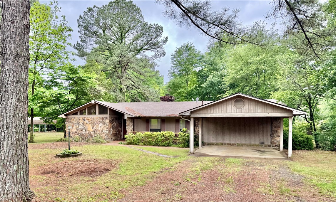 Escape to comfort, and versatility with this charming property set on 3.09 beautiful acres. This home offers the perfect blend of indoor coziness and outdoor living. Step inside to a welcoming living room w/ a warm, inviting fireplace—perfect for relaxing evenings or gathering with family and friends. Just outside, you’ll find both a covered patio and a spacious deck, ideal for entertaining, grilling, or simply enjoying peaceful country views. The property is well-equipped for all your storage and parking needs, featuring a 2-car attached carport for everyday convenience, plus a large detached metal carport—perfect for boats, RVs, etc. A durable metal storage building provides even more space for tools, equipment, or hobbies. With 3.09 acres, there’s plenty of room to roam, garden, or create your own outdoor oasis. Whether you’re looking for a quiet retreat or a property with room to grow, this one checks all the boxes. Don’t miss the opportunity to enjoy country living with practical amenities already in place!