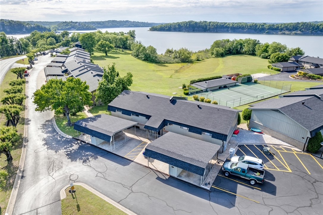 This fully updated, turnkey condo at Heritage Bay off the Hwy 12 bridge is move-in ready and comes completely furnished — just bring your bags! Enjoy breathtaking Beaver Lake views from your private balcony and living area, complemented by thoughtfully curated designer finishes throughout. Conveniently located just minutes from downtown Rogers. Inside, you'll find herringbone LVP flooring, a fully renovated kitchen with updated granite countertops, and a spa-inspired bathroom featuring a stunning tile shower with a glass door, updated granite countertops, refreshed interior paint, trim, and light fixtures throughout. Every detail has been carefully considered, leaving nothing left to update. Outside, enjoy the convenience of your own detached carport along with exceptional community amenities including a sandy beach with lake access, an inground pool, tennis courts, a clubhouse, and a fitness center — all set against the stunning backdrop of Beaver Lake. Property does not come with boat slip.