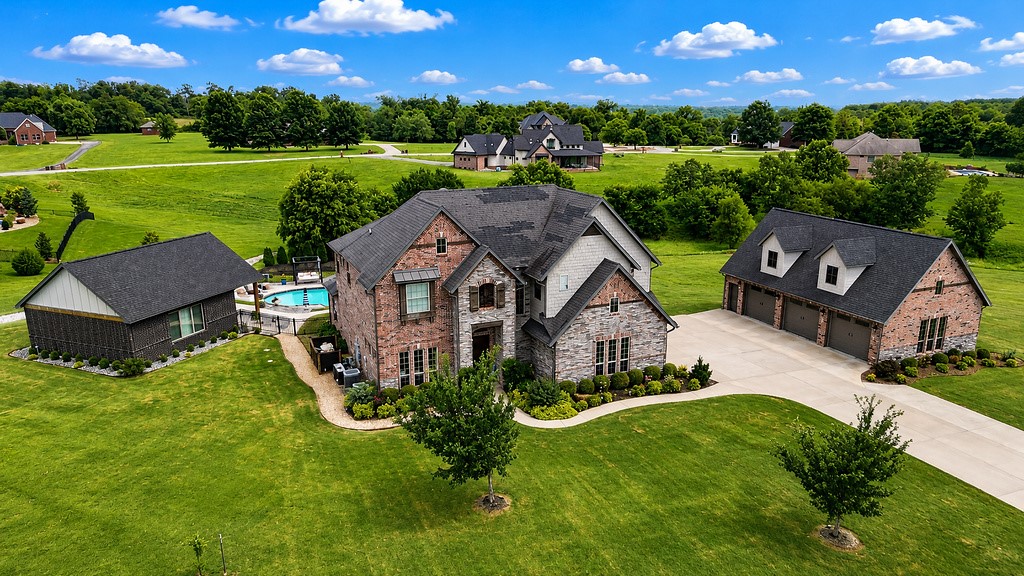 This beautifully maintained property features a 3,142-square-foot main residence with 4 bedrooms and spacious living areas. The private backyard retreat centers around a stunning gunite pool with tanning ledge, expansive pool deck, and professionally designed terraced hardscaping that creates a true resort atmosphere.

A nice bonus is the fully equipped 650-square-foot accessory dwelling unit (ADU) with a full kitchen with large quartz island, living room, bedroom, bathroom, and laundry. With a proven Airbnb history generating approximately $15,000–$16,000 annually, it offers outstanding flexibility for guests, multigenerational living or supplemental income.

The impressive 26’ x 40’ full-brick detached garage/shop provides abundant space for vehicles, hobbies, storage, or workshop needs.

Rarely does a property combine a luxury pool, income-producing guest house, detached brick shop, and exceptional outdoor living—all conveniently located near Bentonville schools, shopping, dining, and recreation.
